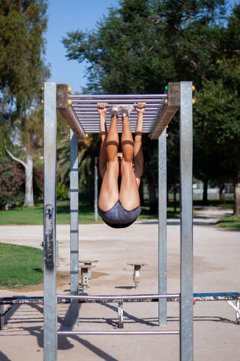 Kim doing her favorite toes-to-bar exercise at an outdoor workout area in Valencia, Spain.