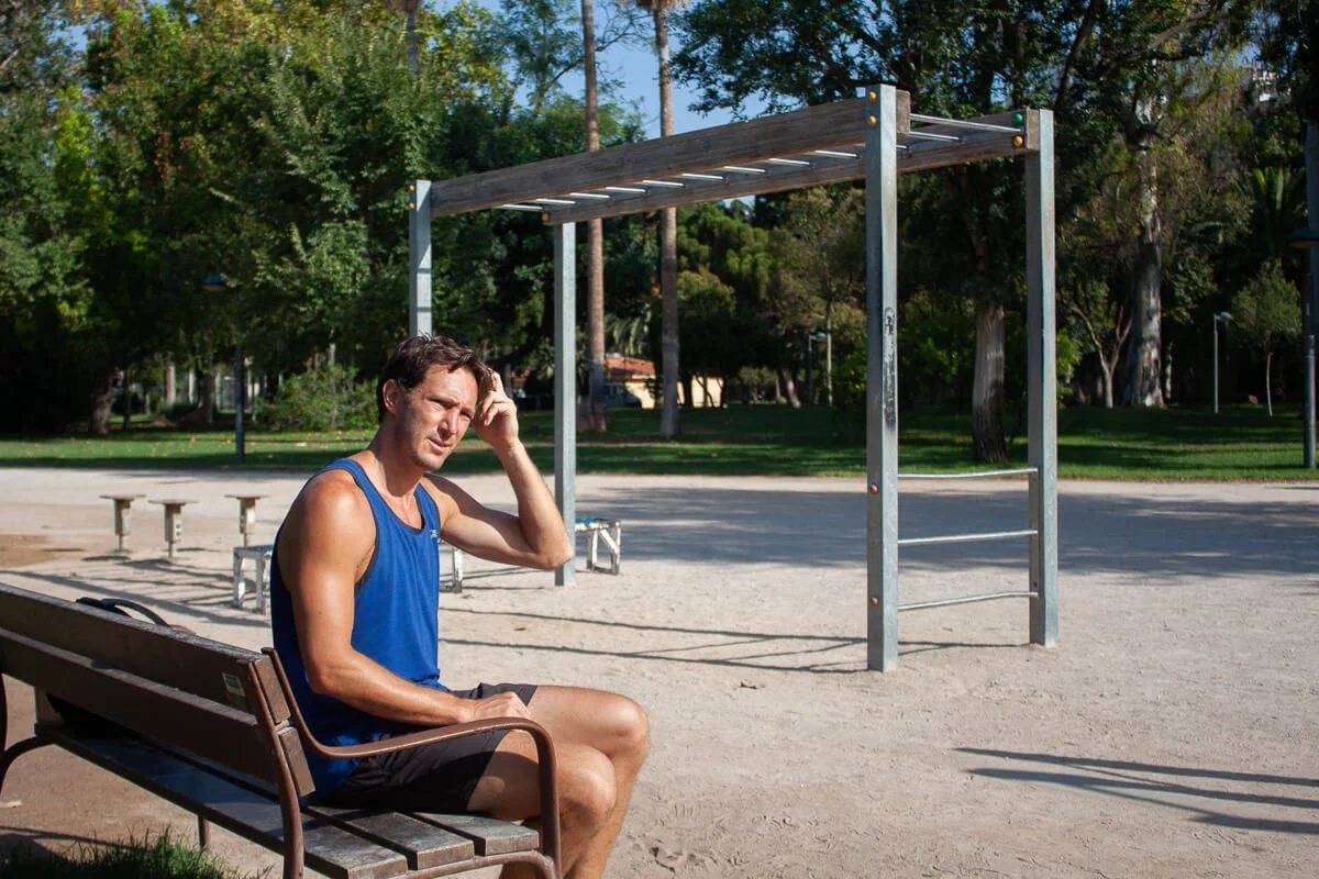 Chris wondering what to do for his outdoor workout, scratching his head.