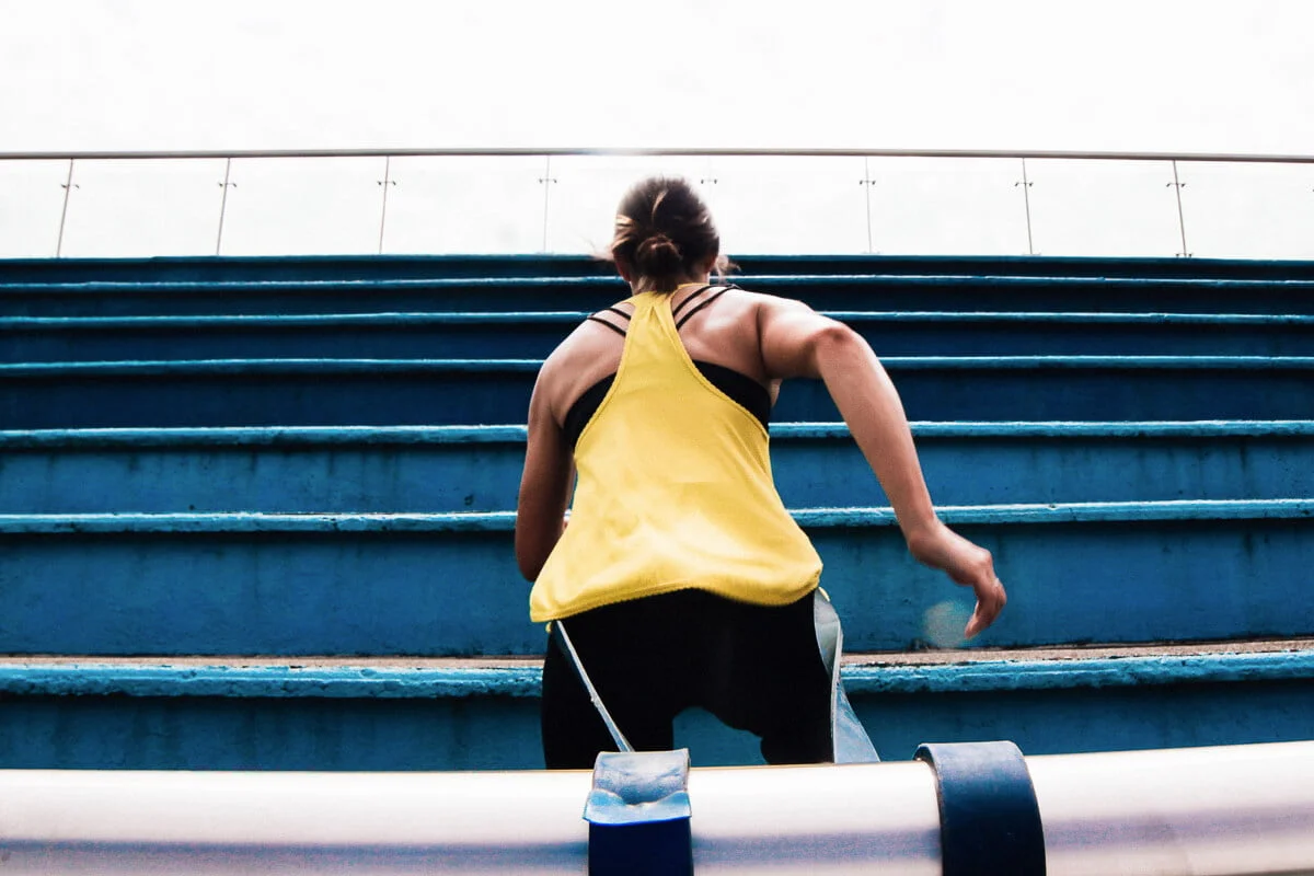 Supernatural Kim doing resistance band training on stairs
