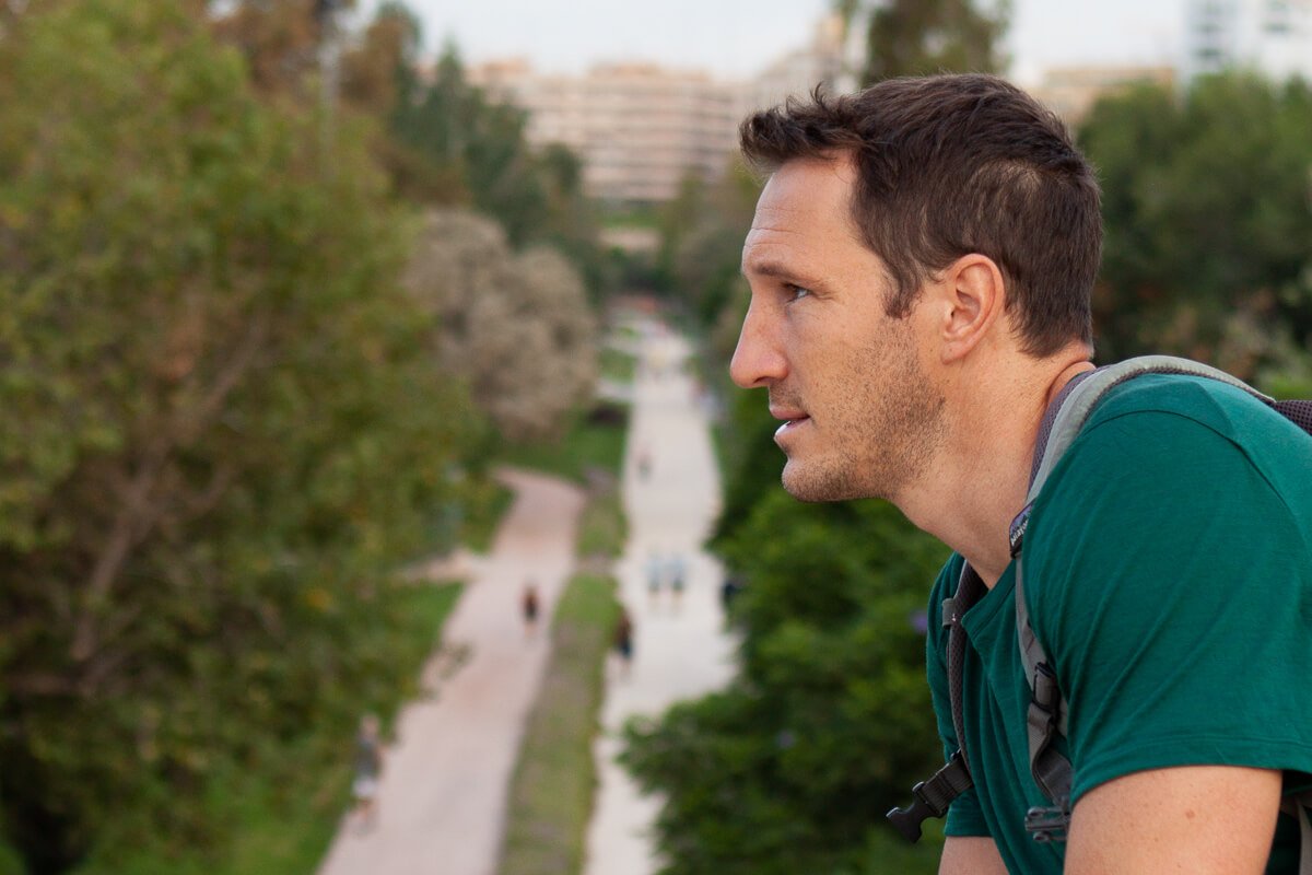 Chris thinking about whether or not he should join the people running below him along La Turia in Valencia