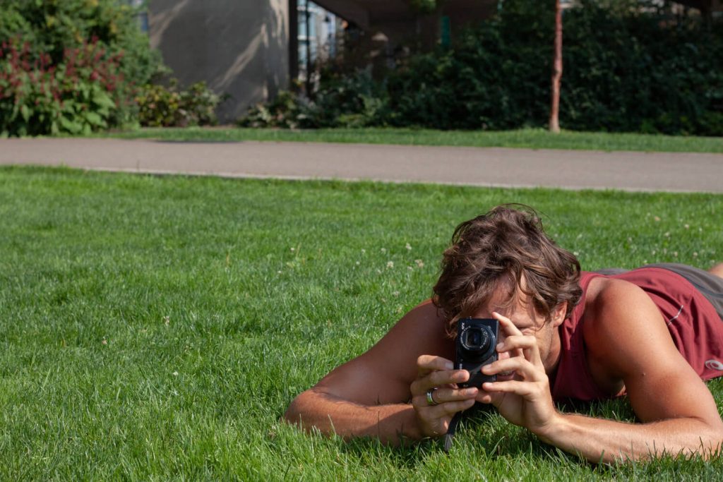 Chris taking photos on grass