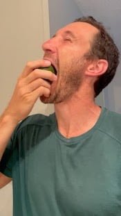 eating a green avocado