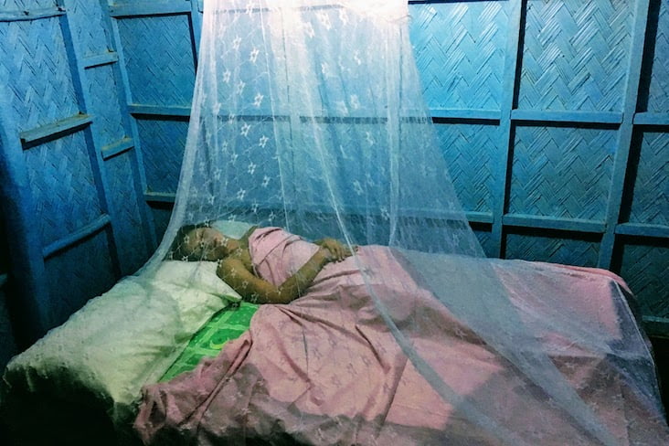 Kim sleeping under mosquito net.