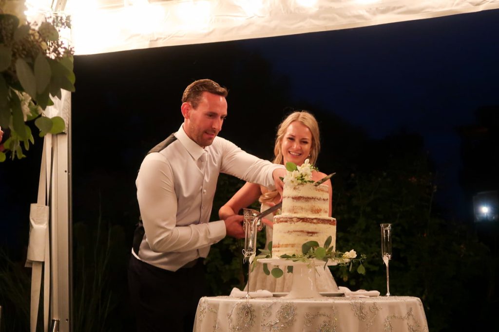 Rob and Laura cutting into their wedding cake Kim made
