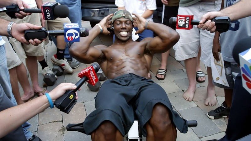Terrell Owens doing sit-ups during interview. 