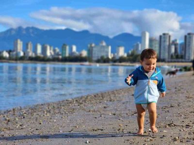 Zac running on beach in Vancouver.